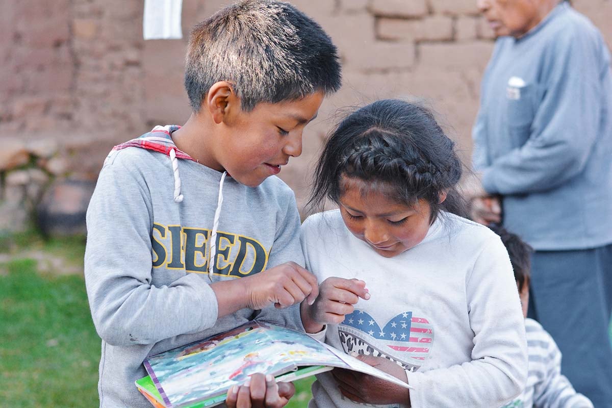 A young boy and a young girl reading together